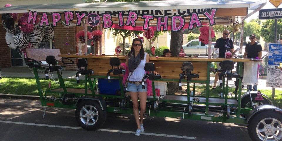 Sac Brew Bike Birthday Brew Bike with birthday decorations, young woman stands in front