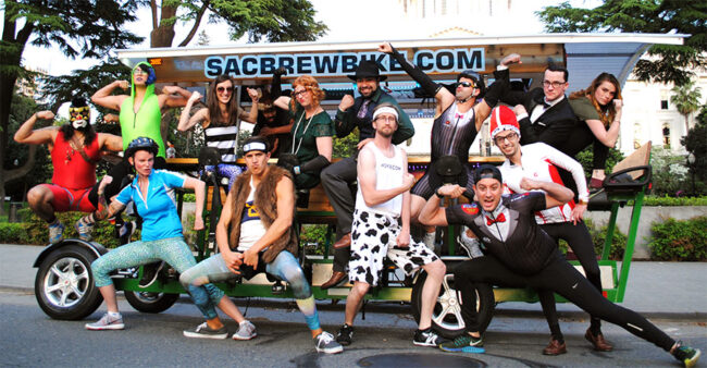 celebration-party-ideas-midtown-sacramento Group celebrating in diverse costumes on a Sac Brew Bike tour