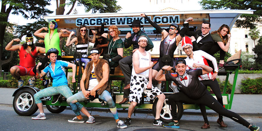 celebration-party-ideas-midtown-sacramento Group celebrating in diverse costumes on a Sac Brew Bike tour